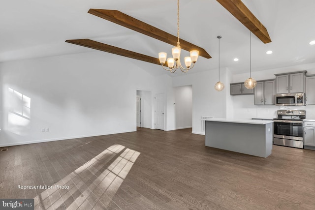 kitchen featuring pendant lighting, dark hardwood / wood-style floors, a kitchen island, and stainless steel appliances