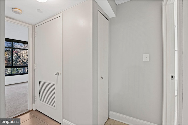 corridor featuring light tile patterned flooring