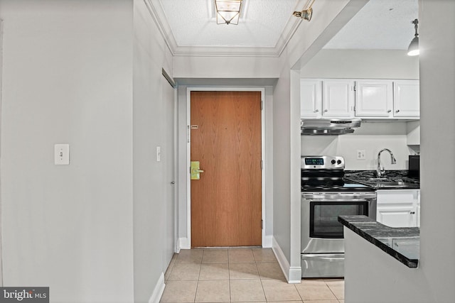 kitchen with sink, light tile patterned floors, electric range, white cabinetry, and range hood