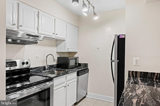 kitchen featuring sink, light tile patterned floors, range hood, white cabinets, and black appliances