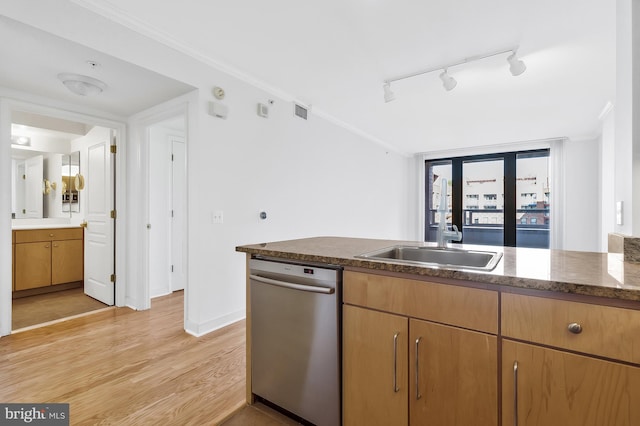 kitchen featuring sink, crown molding, rail lighting, stainless steel dishwasher, and light hardwood / wood-style floors