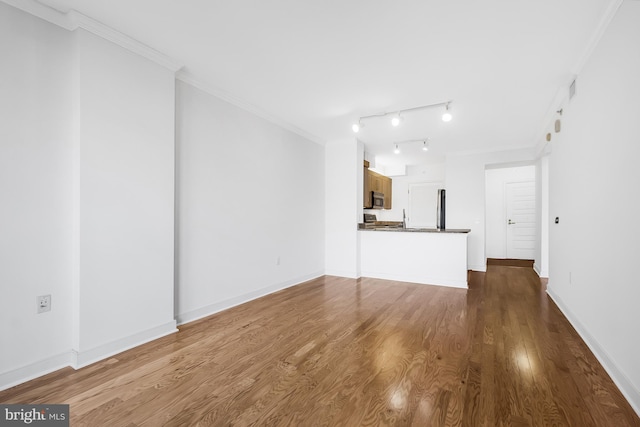 unfurnished living room featuring light hardwood / wood-style flooring and crown molding