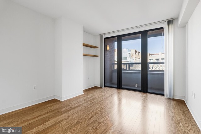 unfurnished room with light hardwood / wood-style flooring