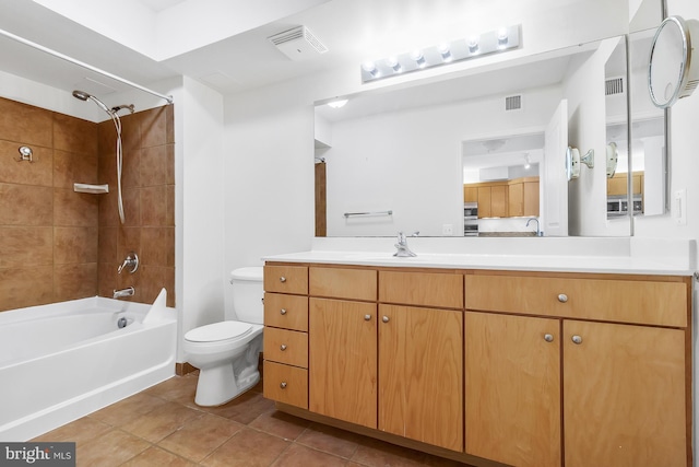 full bathroom featuring tile patterned floors, vanity, toilet, and tiled shower / bath