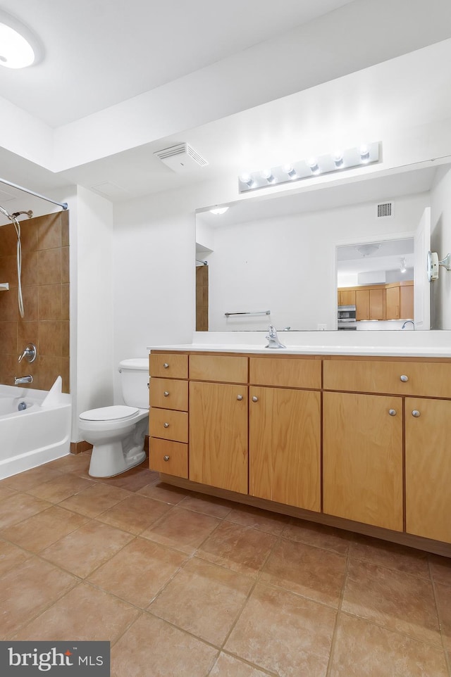 full bathroom featuring tile patterned flooring, vanity, toilet, and tiled shower / bath