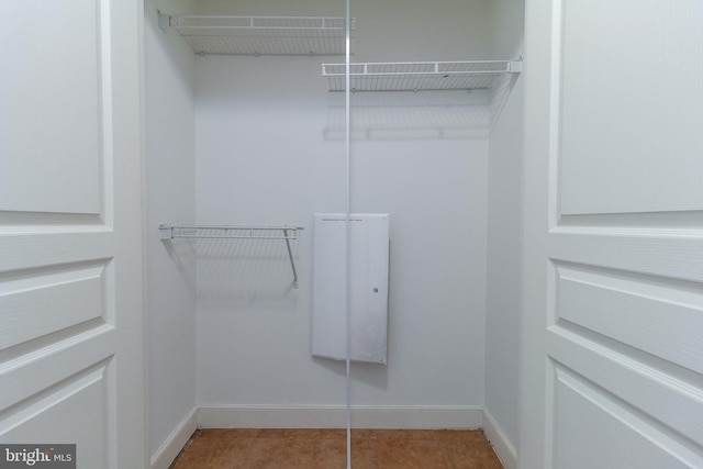 spacious closet featuring tile patterned flooring