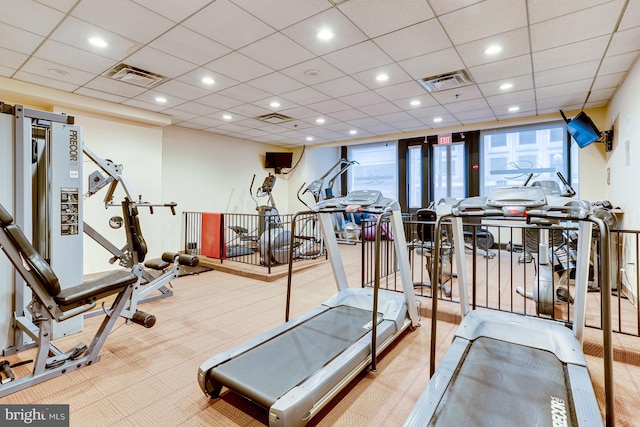 exercise room with a paneled ceiling