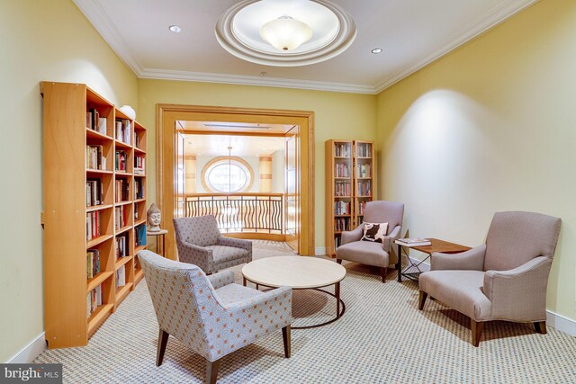 sitting room with crown molding and light colored carpet