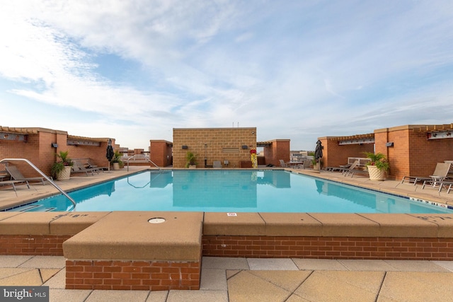 view of swimming pool featuring a patio area