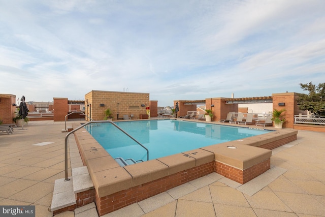 view of swimming pool featuring a patio area