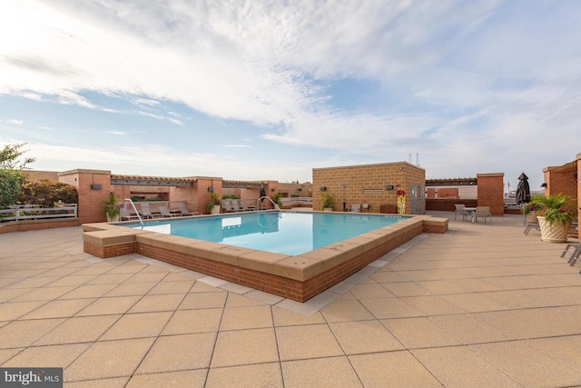 view of swimming pool featuring a patio area