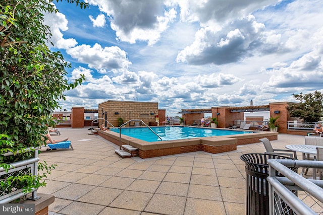 view of swimming pool with a patio area