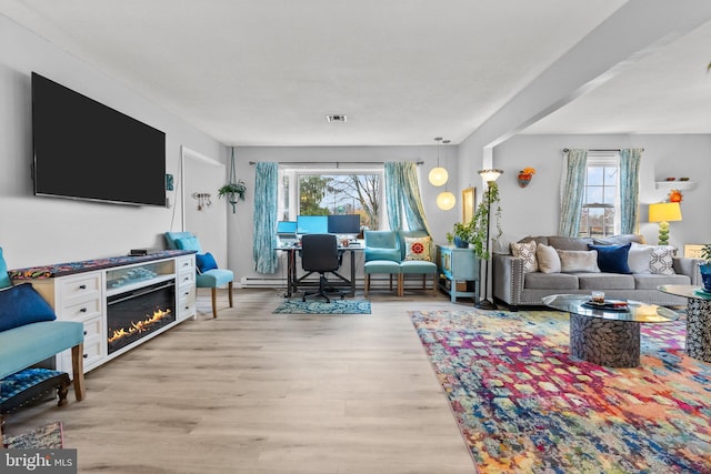 living room with a healthy amount of sunlight and light wood-type flooring