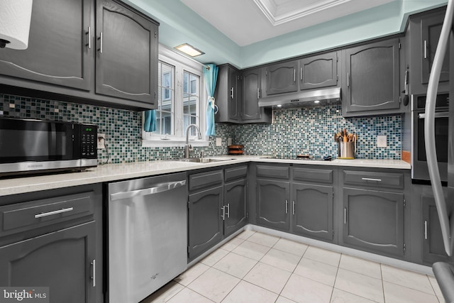 kitchen featuring decorative backsplash, light tile patterned flooring, sink, and stainless steel appliances