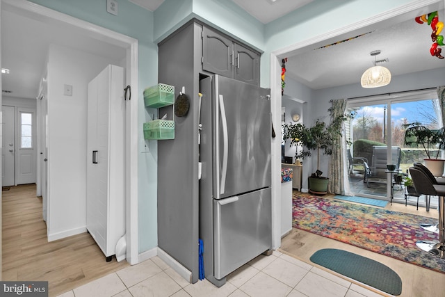 kitchen with stainless steel fridge and light hardwood / wood-style flooring