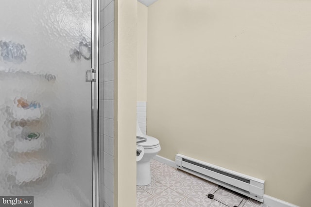 bathroom with a shower with door, toilet, and baseboard heating