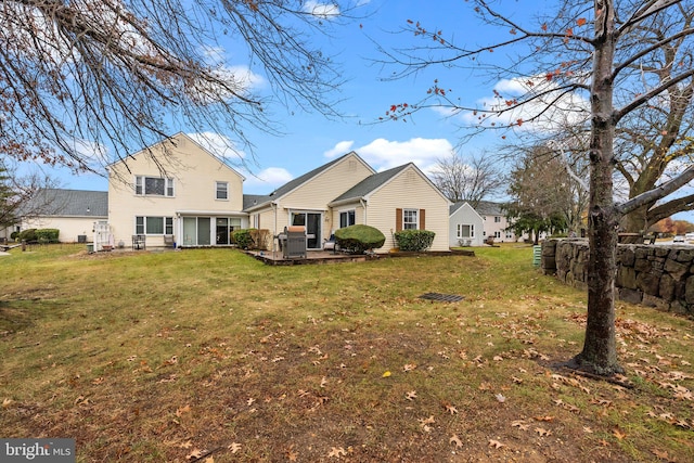 rear view of property with a yard and a patio