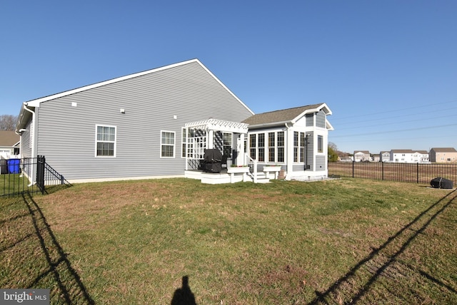 rear view of house featuring a pergola and a yard