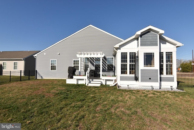 back of property featuring a pergola and a yard