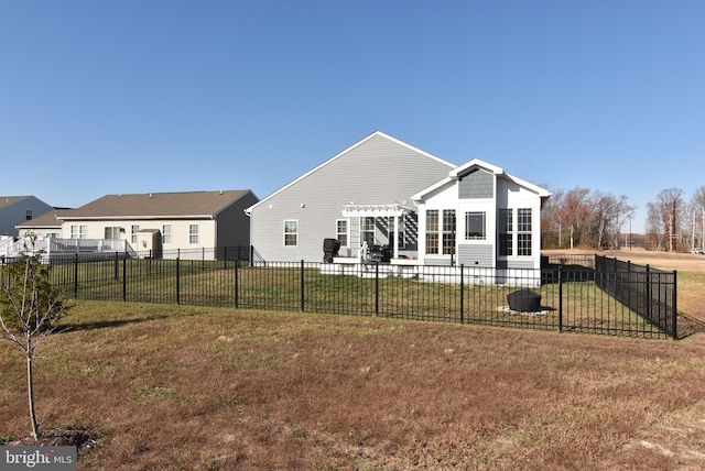 rear view of house with a pergola and a yard