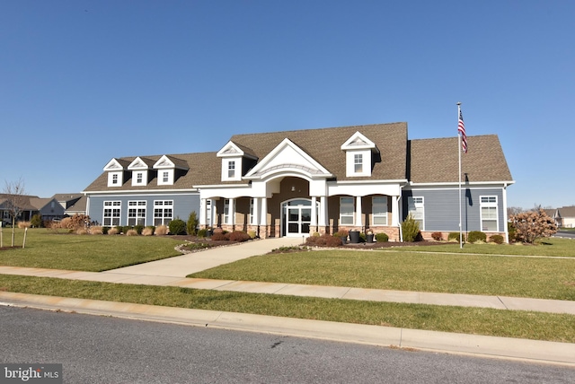 new england style home with a front lawn