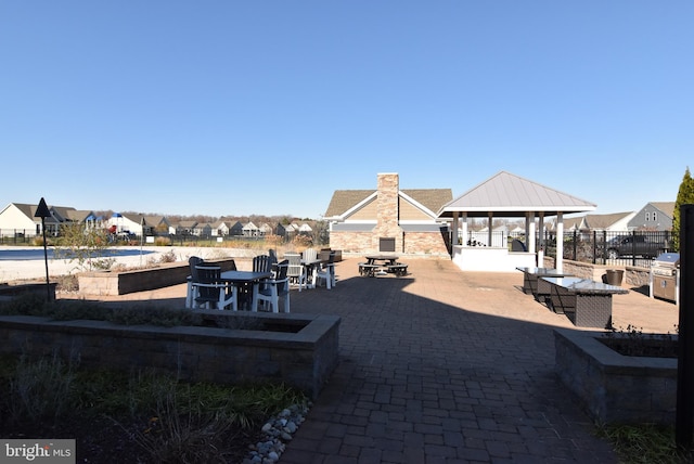 view of patio featuring a gazebo, area for grilling, and exterior bar