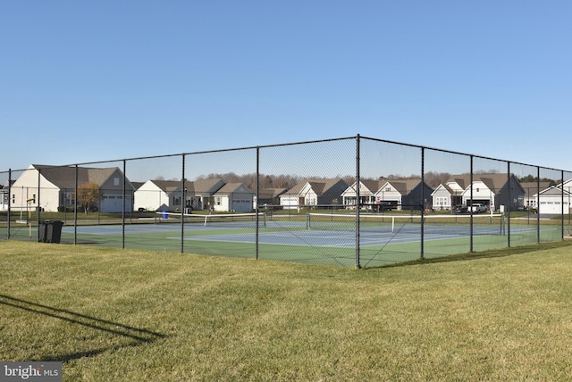 view of sport court with a yard