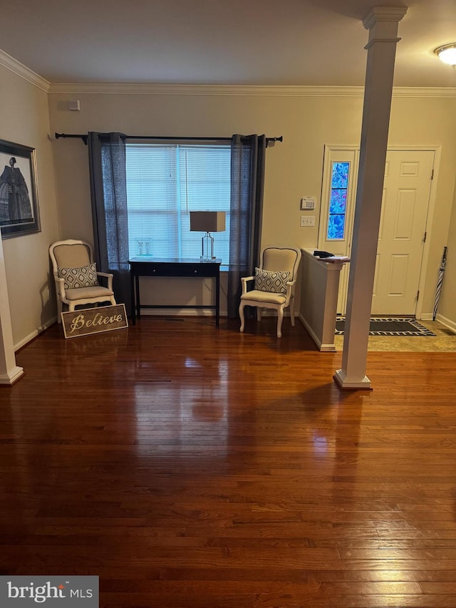 unfurnished room featuring ornamental molding, decorative columns, and dark wood-type flooring