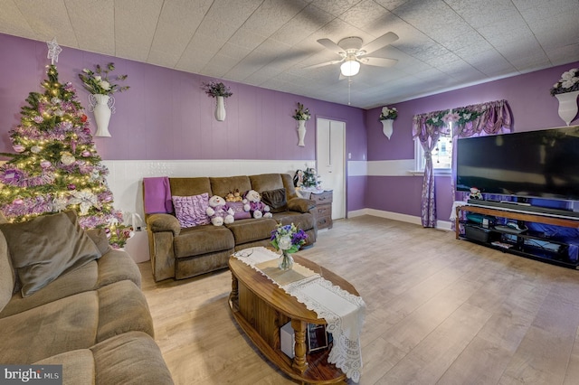 living area with ceiling fan and wood finished floors