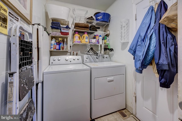 clothes washing area with laundry area and separate washer and dryer