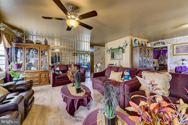 living room with ceiling fan and wood finished floors