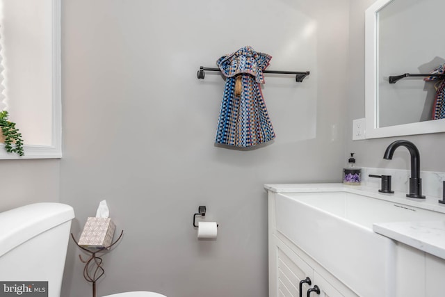 bathroom featuring vanity and toilet