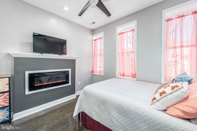 bedroom featuring dark hardwood / wood-style flooring and ceiling fan