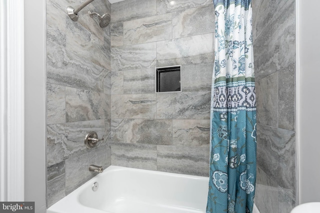 bathroom with shower / bathtub combination with curtain