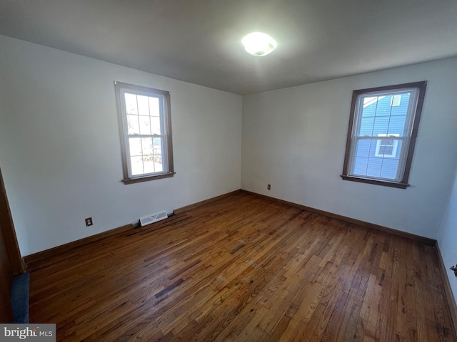 unfurnished room featuring dark wood-type flooring