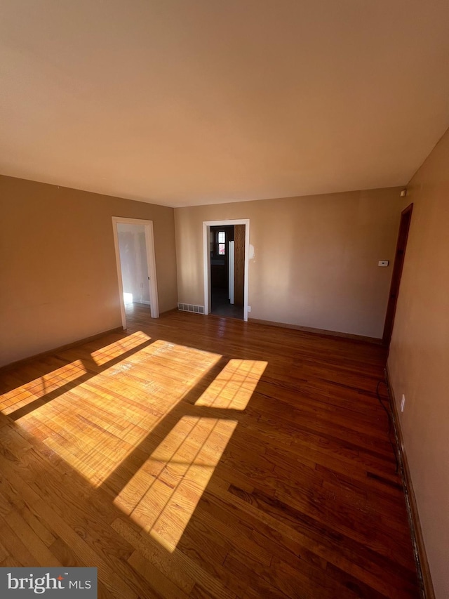 spare room with wood-type flooring