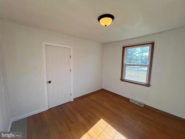 empty room with hardwood / wood-style flooring