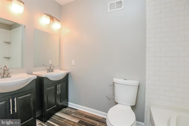 bathroom with vanity, hardwood / wood-style flooring, and toilet