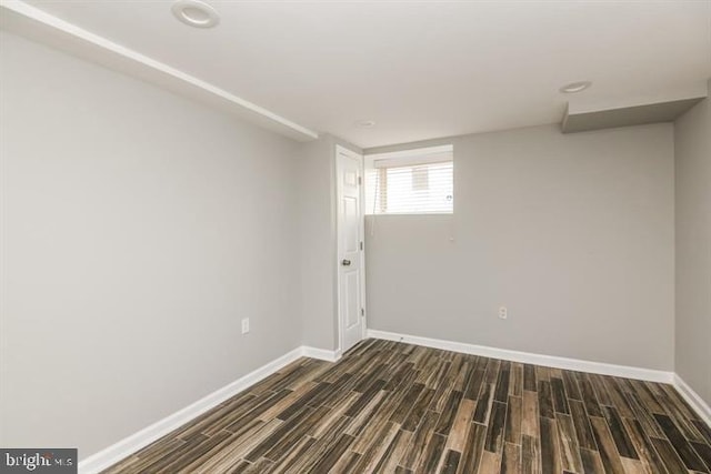 unfurnished room featuring dark wood-type flooring