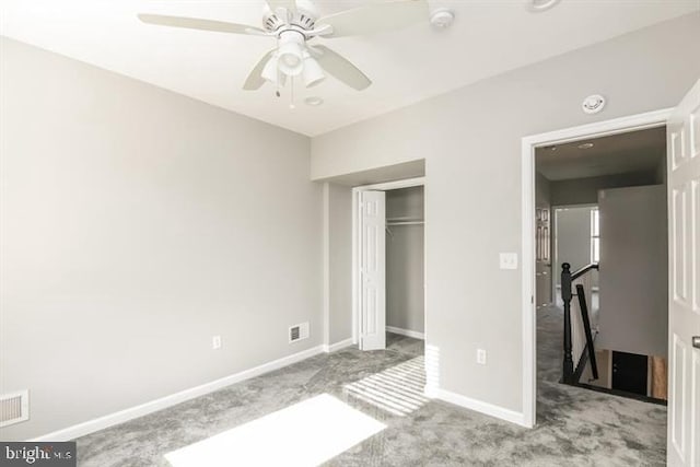 unfurnished bedroom featuring ceiling fan, light colored carpet, and a closet