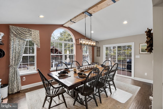 dining room featuring dark wood-type flooring, vaulted ceiling with beams, and a wealth of natural light