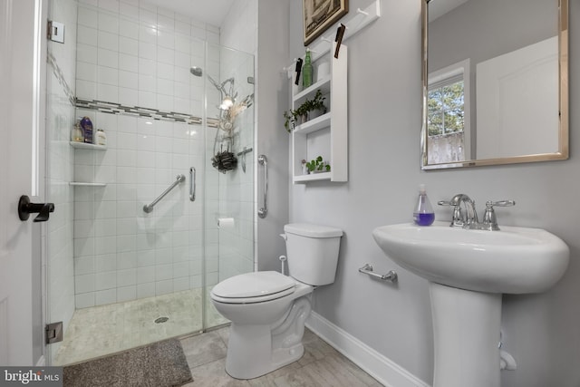 bathroom featuring toilet and walk in shower