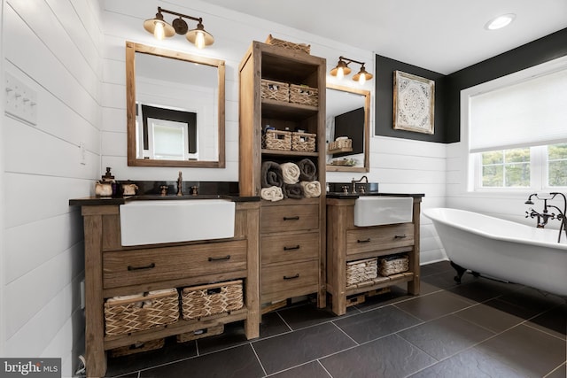 bathroom featuring tile patterned floors, vanity, and a bathtub