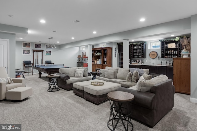 living room featuring billiards, indoor bar, and light colored carpet