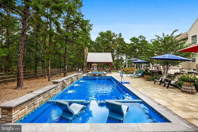 view of swimming pool with a patio area, an in ground hot tub, a gazebo, and pool water feature