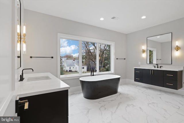 bathroom featuring vanity and a bath