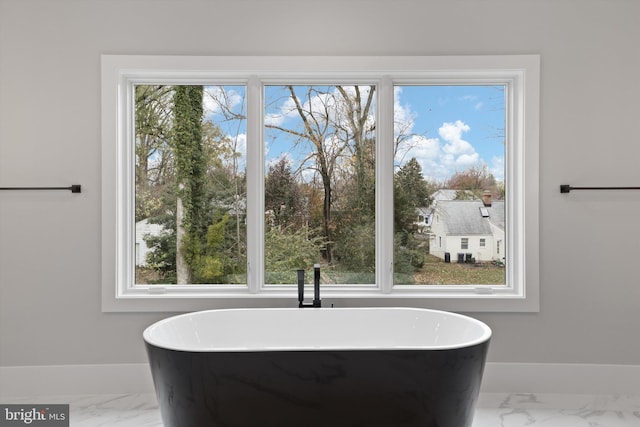 bathroom with a healthy amount of sunlight and a bath