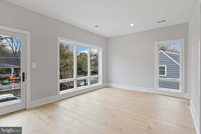 unfurnished room featuring light hardwood / wood-style floors