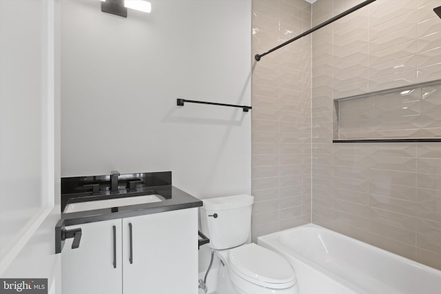 full bathroom featuring vanity, toilet, and tiled shower / bath