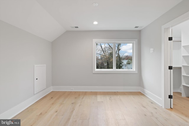 bonus room with light hardwood / wood-style floors and vaulted ceiling